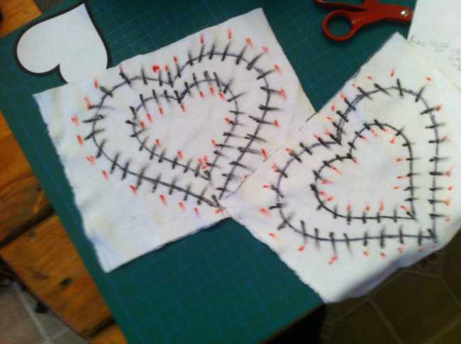 Heart LED stensils drawn on paper with red markings for LED positions